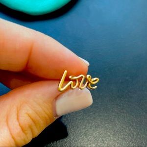 Tiffany’s 18 k rose gold “love” earring stud